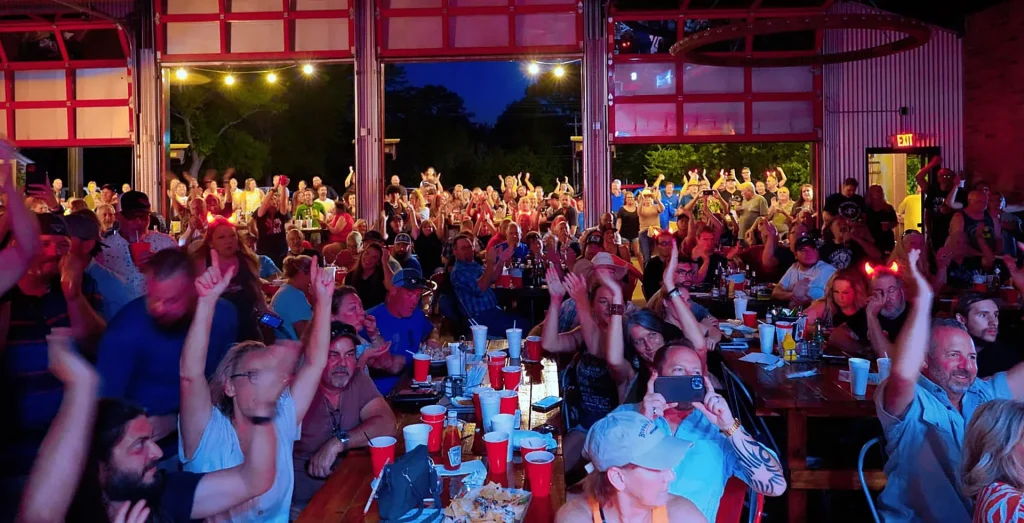 Crowd enjoying outdoor concert night at Red Rooster Ice House in Hawkins